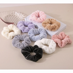 Close-up of soft faux rabbit fur scrunchies set in various pastel colors on display