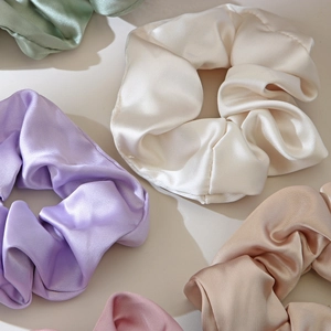 Elegant satin scrunchies set in multi-color pastel tones with silky smooth texture