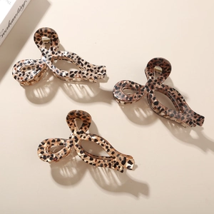 Three-piece leopard print acetate claw clip set with spring-loaded hair grip detail
