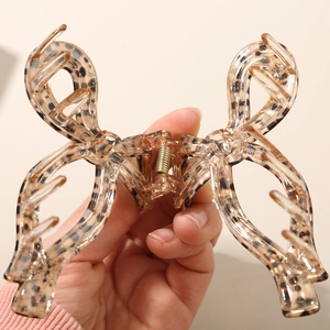Close-up of leopard print acetate hair claw clip showing a strong metal spring and grip