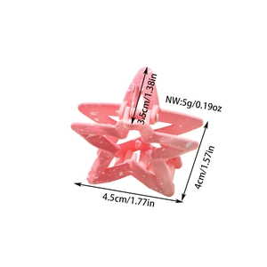 Pink star-shaped matte hair claw clip with white splatter pattern and dimensions