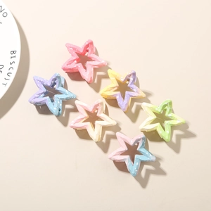Close-up of star hair clips set in pastel colors with marble ink splash texture
