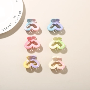 Close-up of 6-piece gradient heart hair claw clips with matte ink splash finish