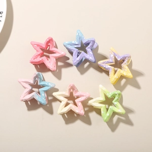 Close-up of star-shaped hair claws in gradient macaron colors with matte finish