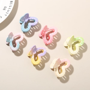 Detailed view of six butterfly hair claws with frosted gradient colors and speckled texture