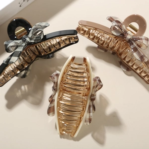 Three-piece acetate hair claw set with elegant plaid bows in black, brown, and cream tones