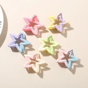 Detailed top view of six gradient star-shaped hair claws with white speckled texture