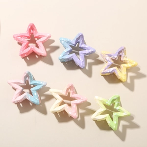 Detailed view of six colorful gradient star-shaped hair claws with white ink splash pattern