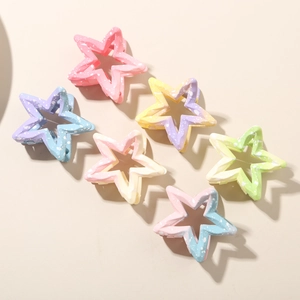 Close-up of star-shaped hair claws with gradient macaron colors and speckled texture