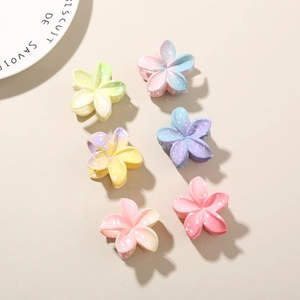 Detailed view of six gradient frangipani hair clips with white speckled texture