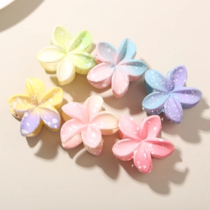 Set of six colorful gradient plumeria hair claws with decorative white polka dots