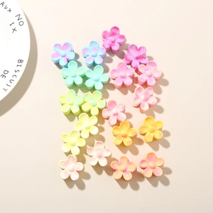 Detail of 2.5cm colorful frangipani hair clips with a glossy gradient finish