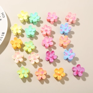 Macro shot of 16 colorful flower claw clips in matte resin with marble texture