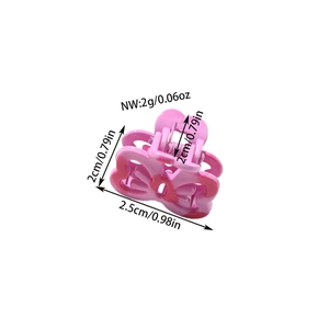 Pink bow-shaped mini shark clip made of resin with glossy texture for hair styling