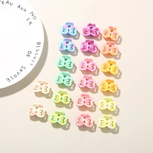Set of 20 mini macaron-colored bow hair clips in various pastel shades and textures
