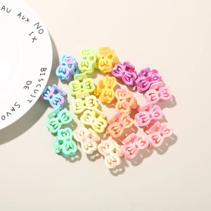 Detailed top view of colorful mini butterfly hair claw clips in a vibrant rainbow assortment
