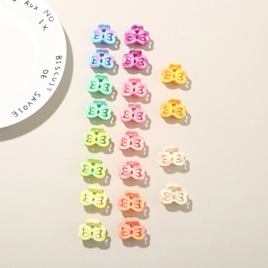 Close-up of small butterfly hair claws in colorful marble and gradient acrylic finishes