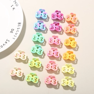 Macro view of 18 piece mini rainbow bow claw clips in colorful marble resin finish