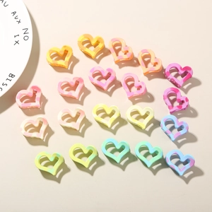 Close-up of 2.5cm heart hair claws in macabre marble textures and pastel colors
