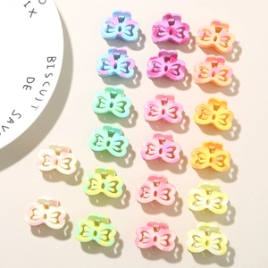 Macro shot of colorful mini 2.5cm plumeria hair clips set with matte marble texture finish