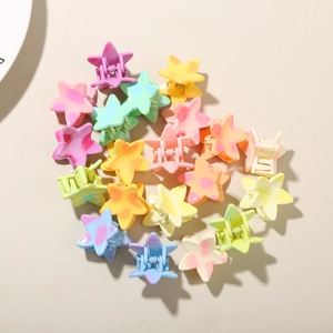 Close-up of star-shaped macaron mini hair claws with pastel gradient and polka dots