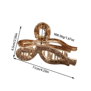 Detail showing the 11cm amber tortoiseshell acetate claw clip with product dimensions