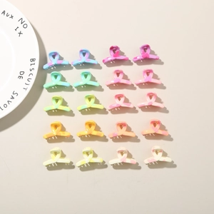 Detailed view of twenty colorful macaron resin hair clips arranged in a neat matrix