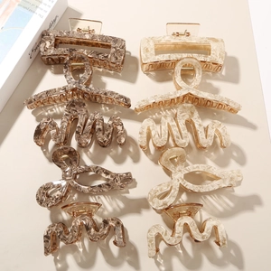 Set of eight assorted acetate hair claws featuring marble and tortoiseshell patterns