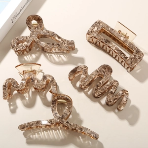 Five styles of large acetate hair claws in marble brown and beige with gold springs