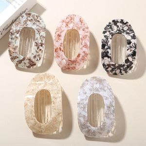Detailed close-up showing five different marble patterns on acetate hair clips