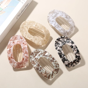 Flat oval acetate hair clips in various patterns including floral, marble, and tortoiseshell