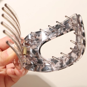 Flat round acetate hair clip with grey marble pattern and metal spring for women