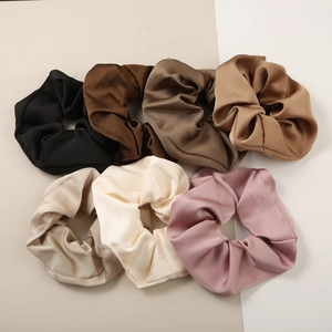 Set of seven assorted satin scrunchies in neutral earth tones with a glossy silk finish
