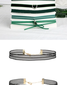 Detail of velvet and lace choker necklaces with heart pendants and emerald green stones