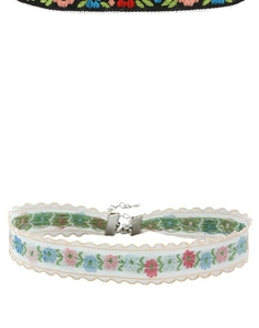 Detail of white lace choker with floral embroidery and adjustable silver lobster clasp