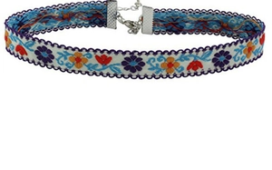Detail showing white fabric choker with floral embroidery and adjustable silver lobster clasp