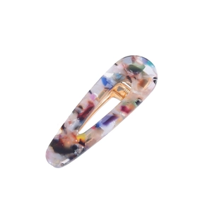 Close-up of acetic acid hair clip with colorful marble pattern and metal fastener