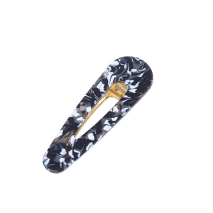 Close-up of marble pattern acetate duckbill hair clip with golden alloy spring
