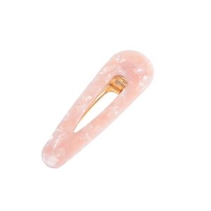 Detailed macro view of pink marble acetate hair clip with golden alloy metal fastener