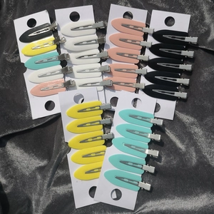 Macro detail of seamless surfboard leaf hair clips in multiple colors on card