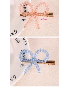 Détail des pinces à cheveux nœud perlé de 6,5cm en rose et bleu avec clips dorés