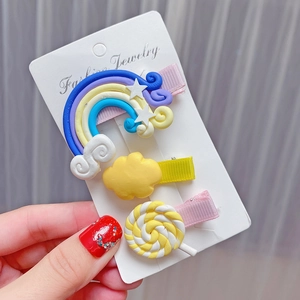 Detailed shot of cute rainbow and candy hair clips set for girls on a jewelry card