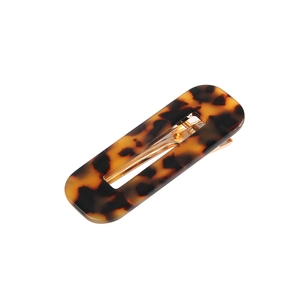Detailed close-up of a hollow rectangular acetate hair clip with leopard amber pattern