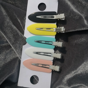 Set of 5 colorful matte crease-free hair clips displayed on a white card over velvet