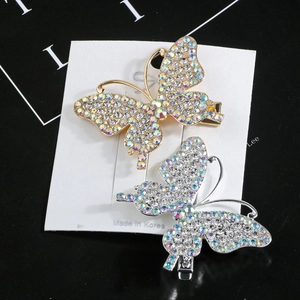 Detail shot of gold and silver butterfly hair clips with shimmering AB rhinestones