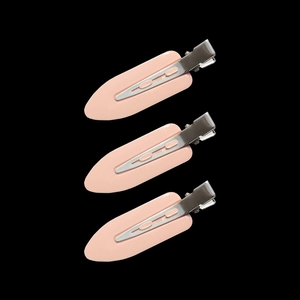 Close-up of three pink no-crease hair clips with matte finish and metal alligator base