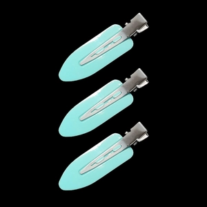 Macro detail of three mint green leaf hair clips with silver metal duckbill base