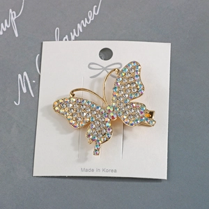 Elegant gold butterfly hair clip with sparkling AB rhinestones on a white display card