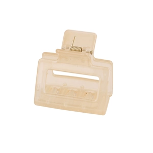 Close-up of a cream-colored rectangular hollow hair claw clip with golden metal spring