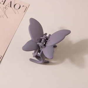 Détail de la pince à cheveux papillon violet mat avec mécanisme à ressort métallique